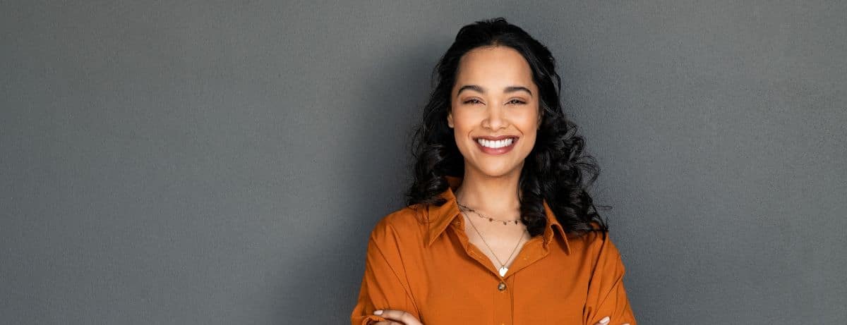 woman in orange smiling